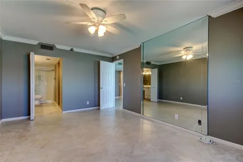 an empty room with fan and entrance
