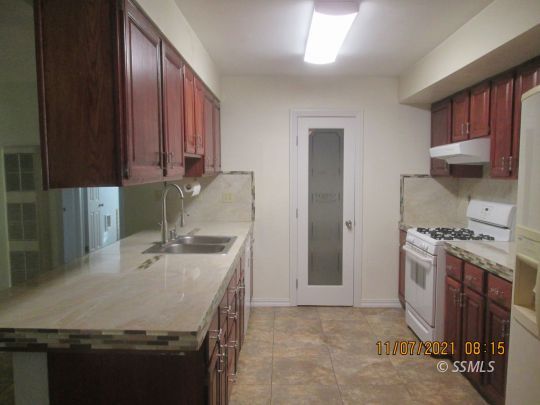 227 South Springside Street Ridgecrest, CA 93555 - Photo 6 of 22 a kitchen with stainless steel appliances granite countertop a sink stove and refrigerator
