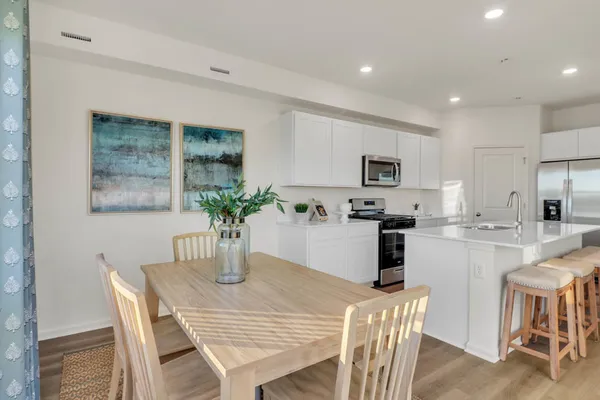a kitchen with a table and chairs in it