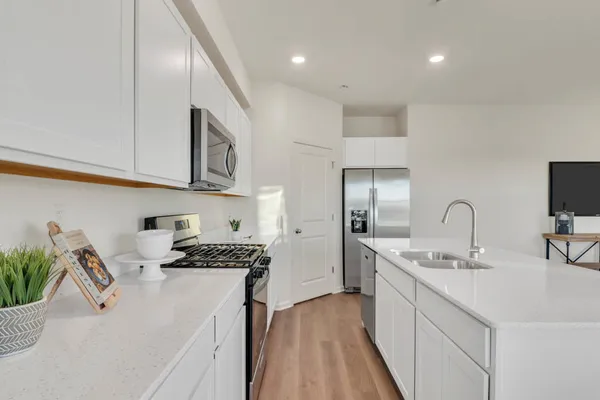a kitchen with a sink stainless steel appliances and cabinets