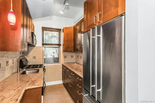 a kitchen with granite countertop a sink and a stove