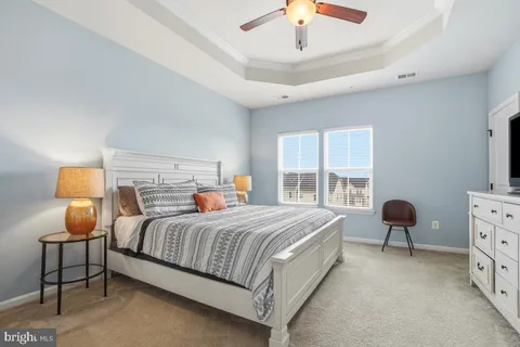 a bedroom with a bed chair and window