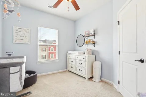 a room with a baby crib gym equipment and a window