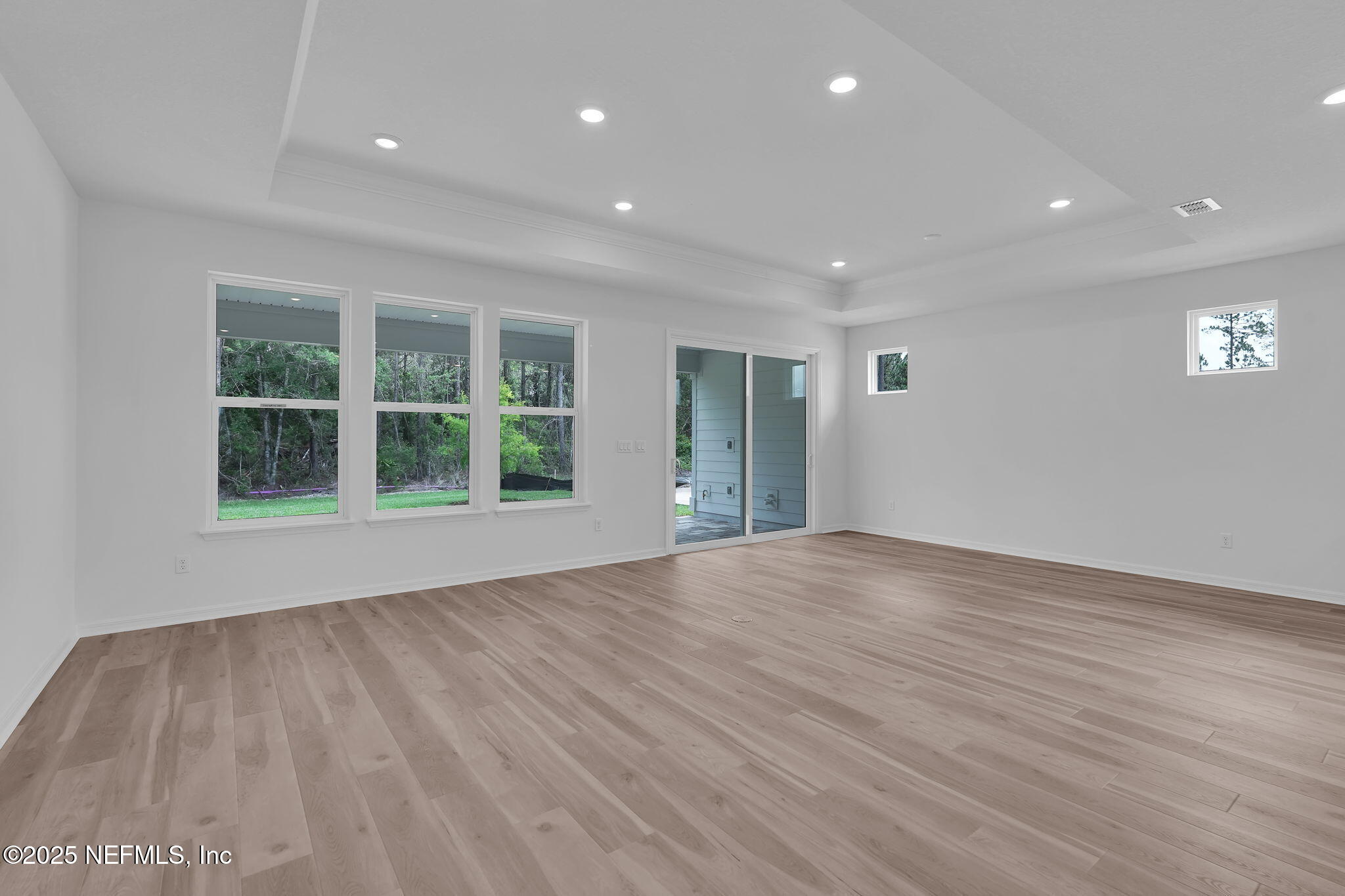 104 Headstream Drive St. Johns, FL 32259 - Photo 10 of 26 a view of an empty room with wooden floor and a window