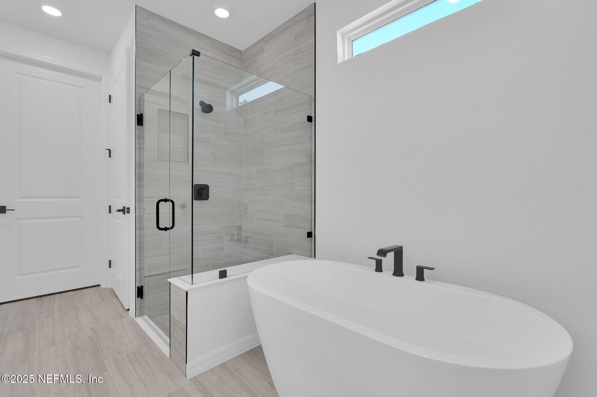 104 Headstream Drive St. Johns, FL 32259 - Photo 15 of 26 a white bath tub sitting next to a white sink and a shower