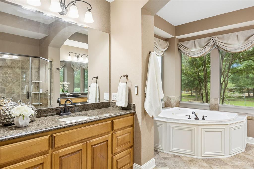 5802 Corinth Chapel Road Parker, TX 75002 - Photo 17 of 40 The primary bathroom offers dual vanities with granite countertops, great storage and tons of natural light.