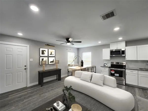 a living room with furniture a fireplace and a flat screen tv