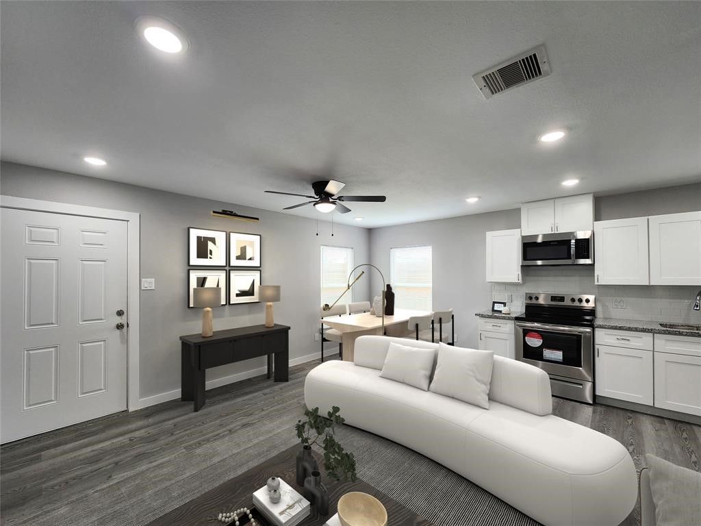 a living room with furniture a fireplace and a flat screen tv