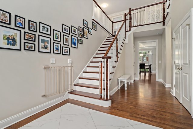 1032 South Spring Avenue La Grange, IL 60525 - Photo 4 of 44 a view of staircase with white walls and wooden floor