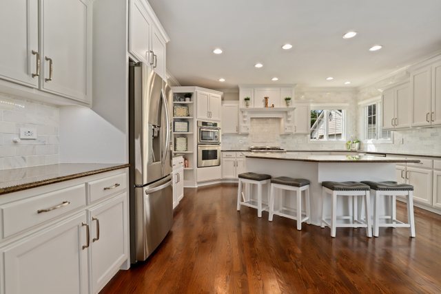 1032 South Spring Avenue La Grange, IL 60525 - Photo 10 of 44 a kitchen with stainless steel appliances granite countertop a white cabinets and wooden floor