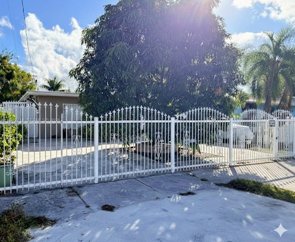2118 Northwest 86th Street Miami, FL 33147 - Photo 2 of 10 a view of a wrought iron fences in front of house