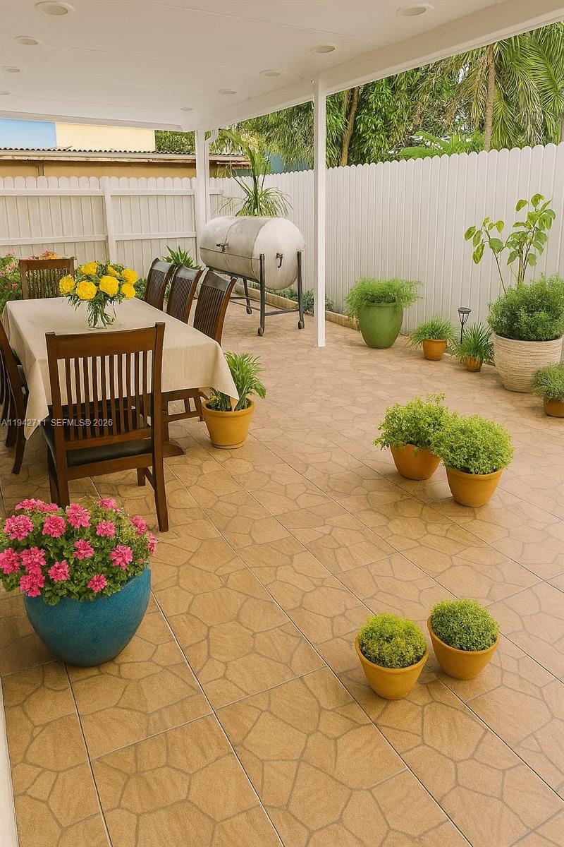 2118 Northwest 86th Street Miami, FL 33147 - Photo 3 of 10 a view of a chairs and table in backyard