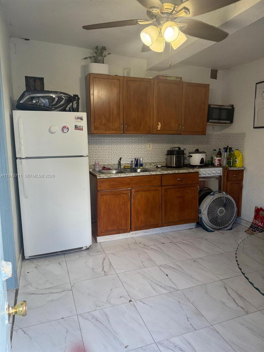 2118 Northwest 86th Street Miami, FL 33147 - Photo 7 of 10 a kitchen with a cabinets and white appliances