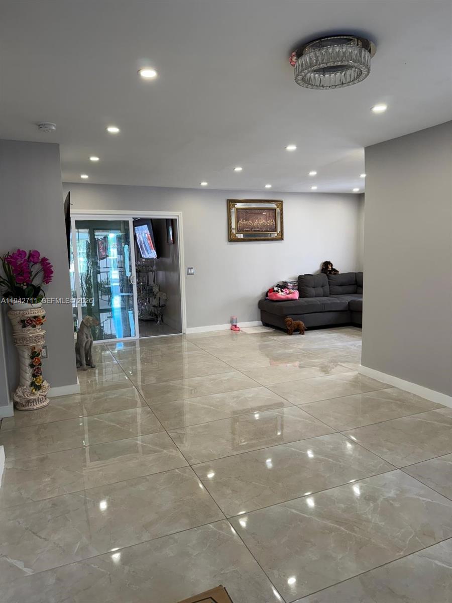 2118 Northwest 86th Street Miami, FL 33147 - Photo 10 of 10 a living room with furniture and a chandelier