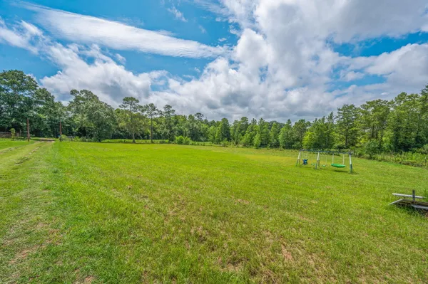 a view of a big yard with a house in the background