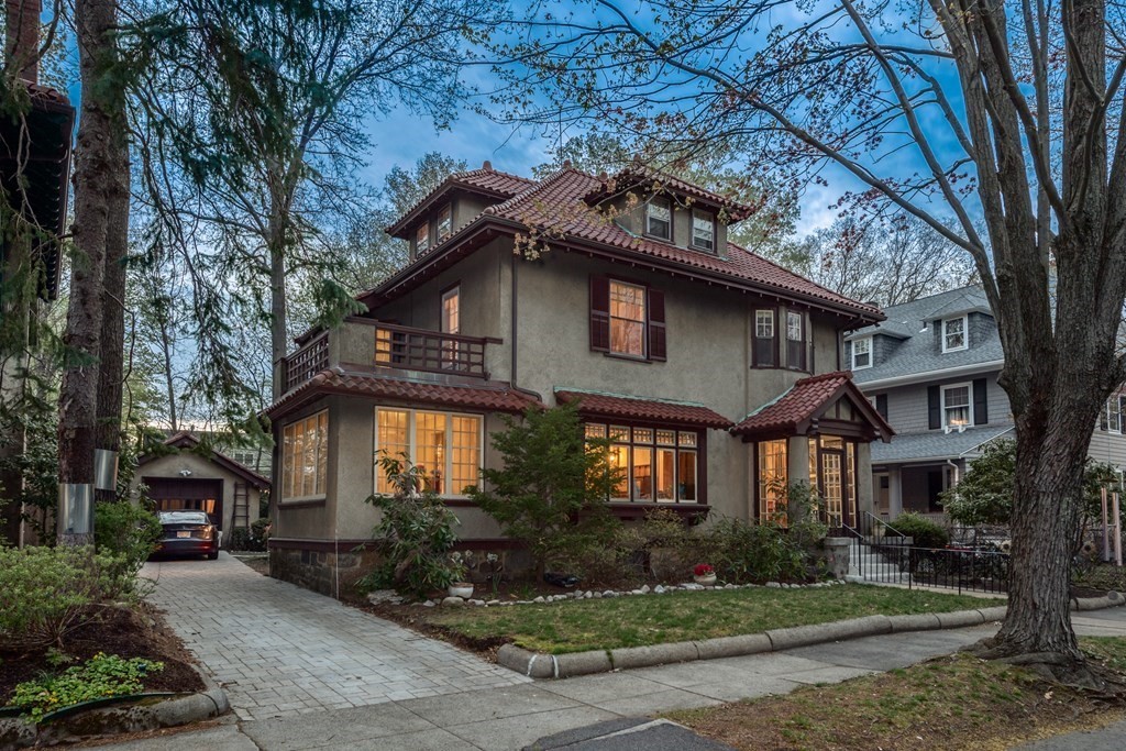 a front view of a house with a yard and outdoor seating