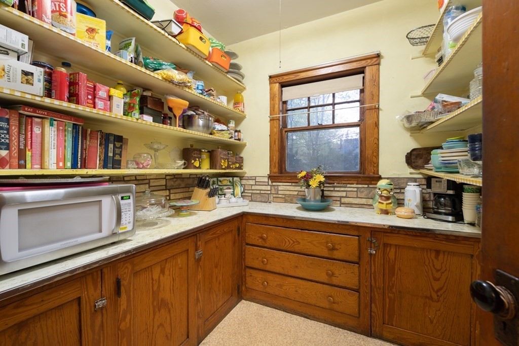67 Crowninshield Road Brookline, MA 02446 - Photo 12 of 23 a kitchen with cabinets and window