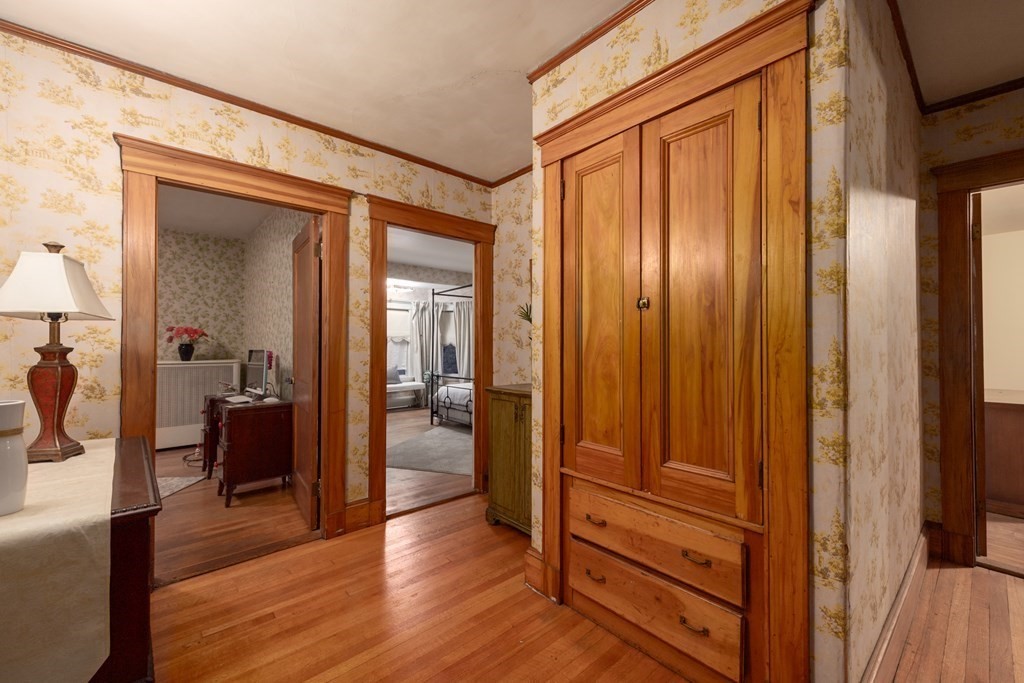 67 Crowninshield Road Brookline, MA 02446 - Photo 14 of 23 a view of a hallway with wooden floor and closet