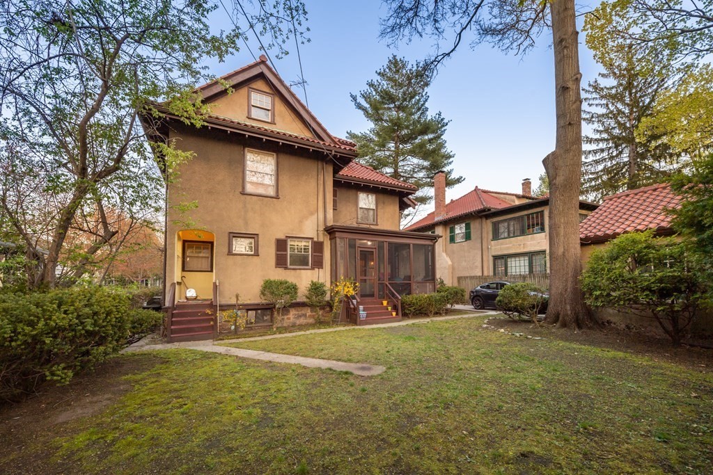 67 Crowninshield Road Brookline, MA 02446 - Photo 20 of 23 a front view of a house with a yard