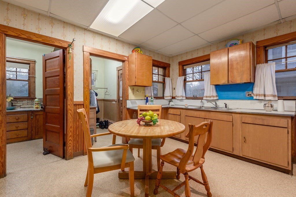 67 Crowninshield Road Brookline, MA 02446 - Photo 10 of 23 a kitchen with stainless steel appliances granite countertop a stove a sink a table and chairs
