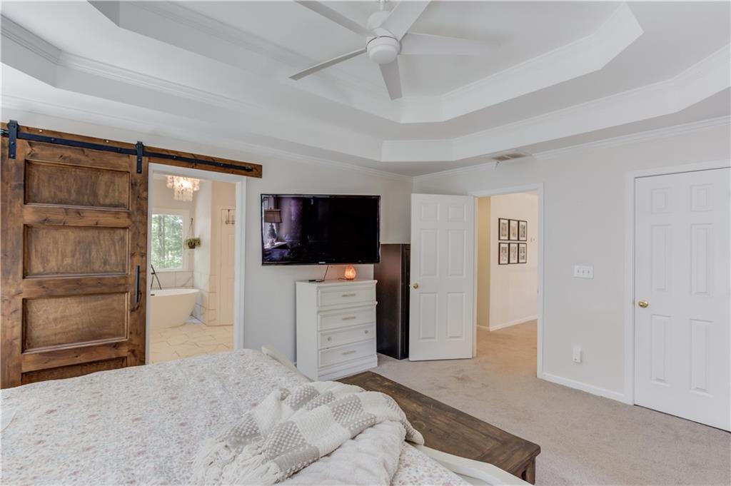 2310 Olde Hickory Place Monroe, GA 30656 - Photo 19 of 46 a bedroom with a bed and a flat screen tv