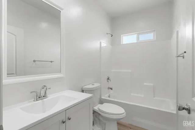 a bathroom with a sink toilet vanity and shower