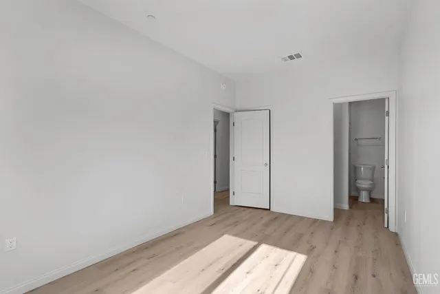 a view of an empty room and wooden floor