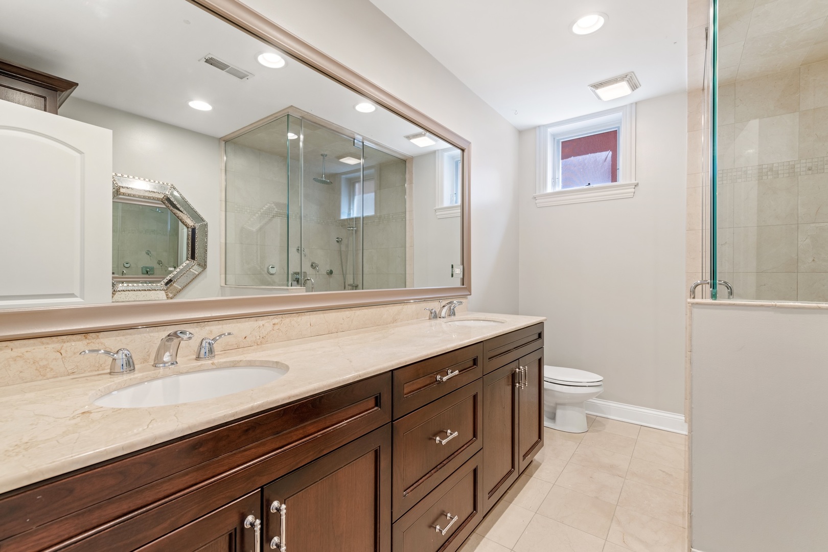 2620 North Racine Avenue, Unit 2S Chicago, IL 60614 - Photo 12 of 14 a bathroom with a granite countertop sink a toilet and a mirror