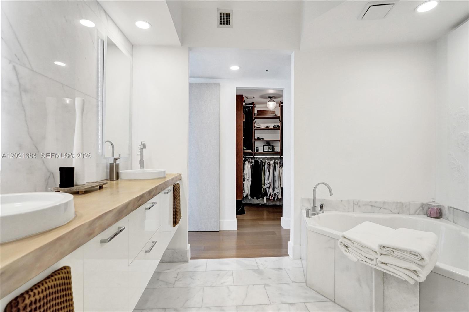 400 Alton Road, Unit PH11 Miami Beach, FL 33139 - Photo 31 of 49 a spacious bathroom with a tub sink and mirror