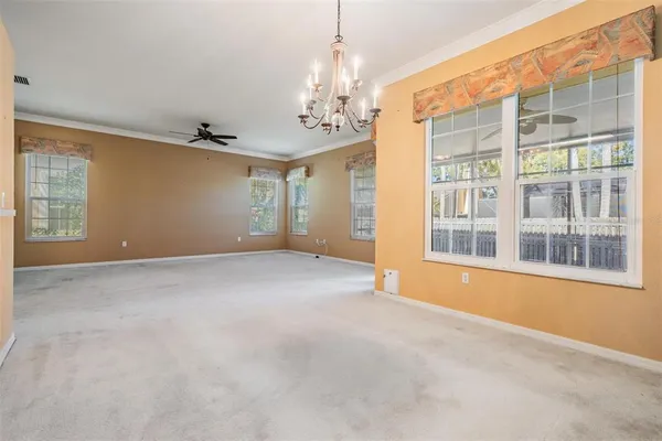 an empty room with sliding door and large windows