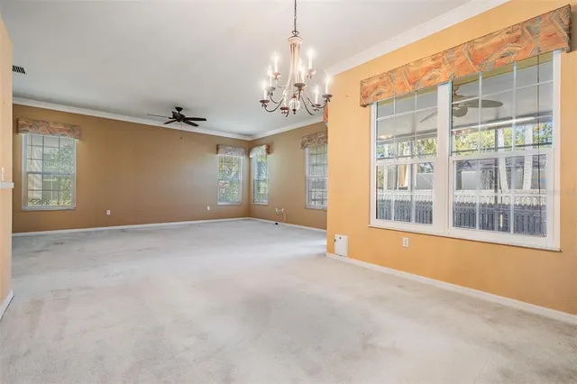 an empty room with sliding door and large windows