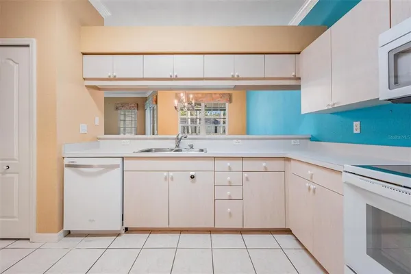 a kitchen with a white cabinets and white appliances