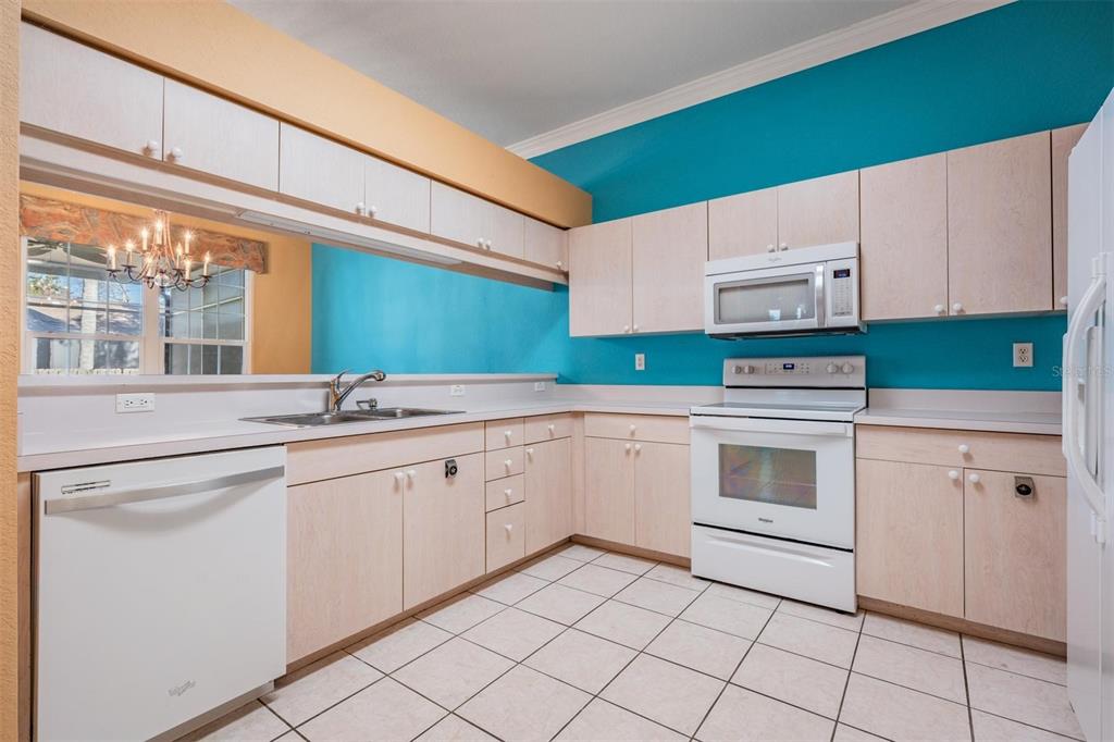 3494 Primrose Way Palm Harbor, FL 34683 - Photo 9 of 68 a kitchen with white cabinets appliances and a sink