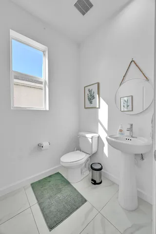 a spacious bedroom with a bed and a flat screen tv