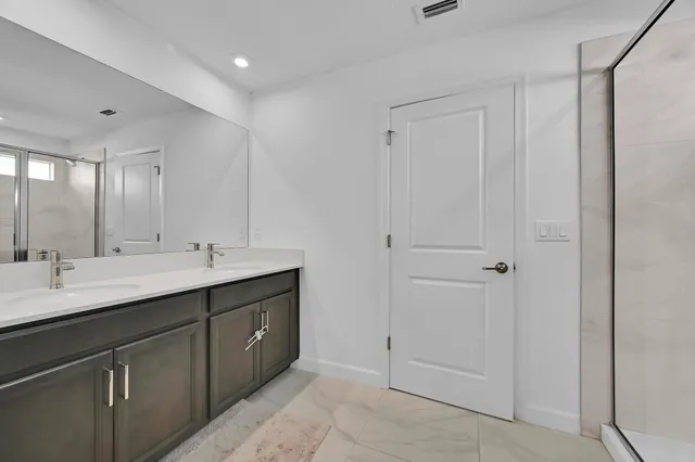 a bathroom with a glass shower door