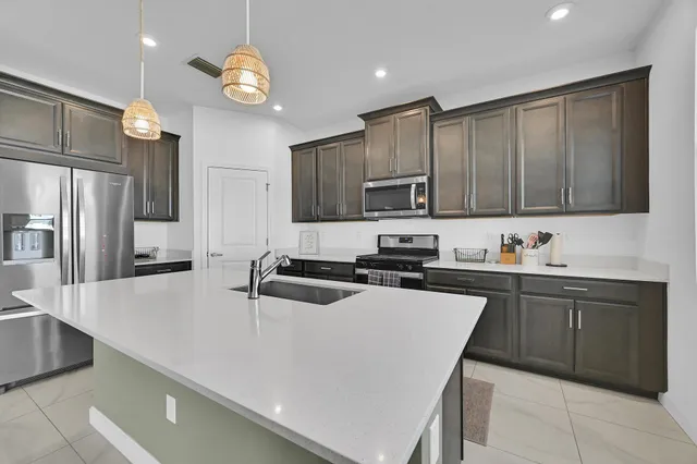 a living room with furniture a flat screen tv and a large window