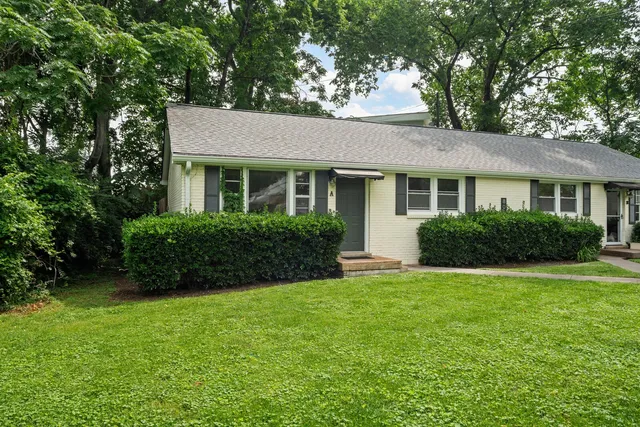 a view of house with a yard