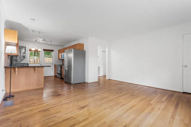 a view of a kitchen with wooden floor and a kitchen
