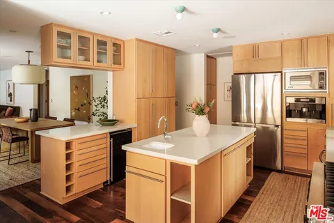 a kitchen with a sink stove and refrigerator