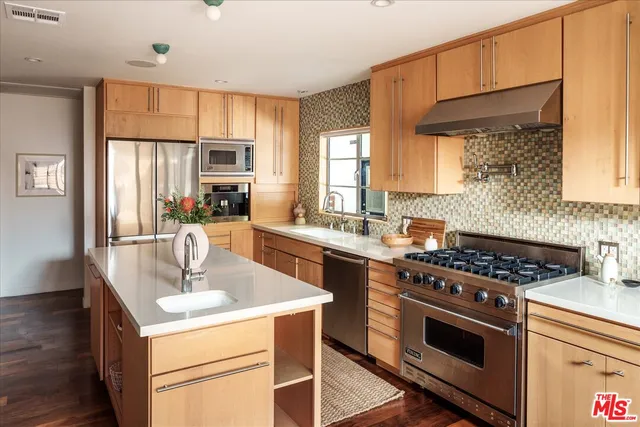 a kitchen with a stove a sink and a microwave