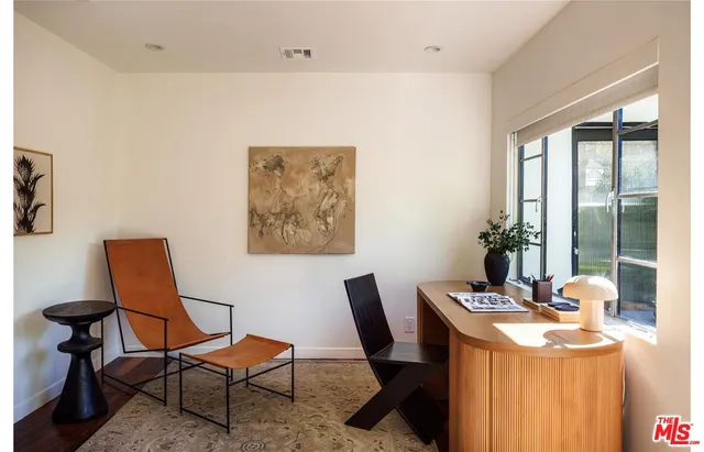 a room with wooden floor and two chair