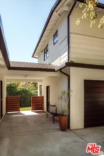 a kitchen with a dining table chairs and living room