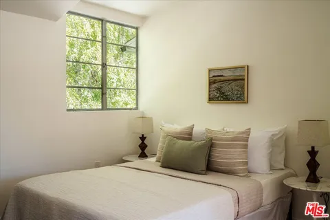 a balcony with wooden floor table and chairs