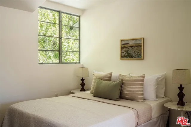 a balcony with wooden floor table and chairs