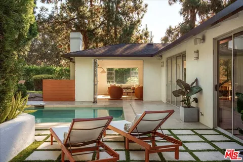 a backyard of a house with table and chairs
