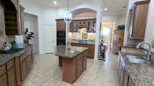a kitchen with granite countertop a sink and cabinets
