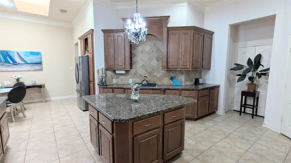 a kitchen with stainless steel appliances granite countertop a sink dishwasher stove and refrigerator with wooden floor