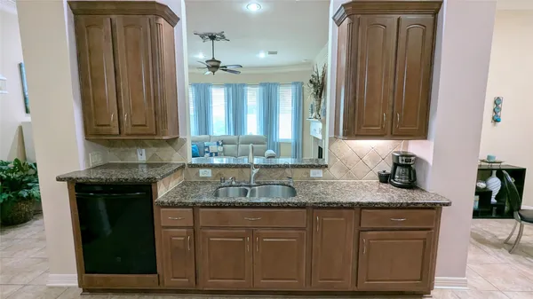 a kitchen with granite countertop cabinets sink and stove