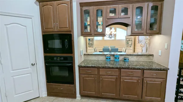 a bathroom with a granite countertop double vanity sink and a mirror