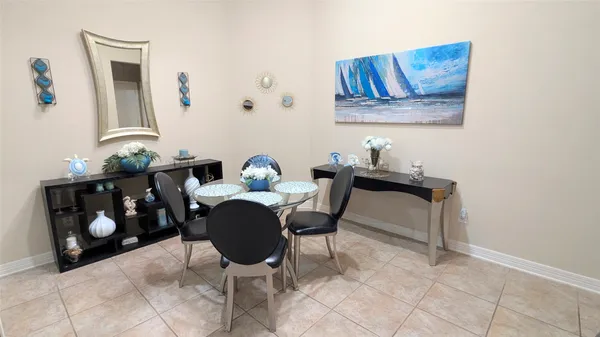 a dining room with furniture and a mirror